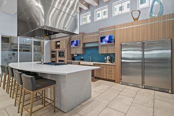 A modern kitchen with a large island and stainless steel appliances.
